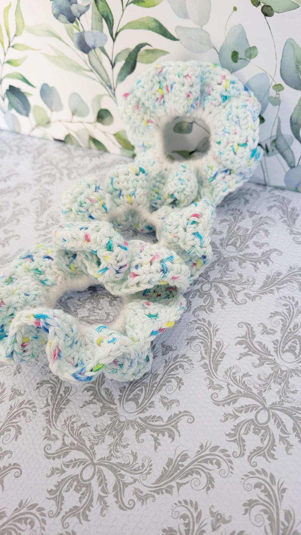 Crocheted item with colorful sprinkles on a decorative background