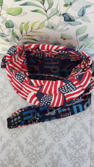 Multicolored fabric crossbody purse with American flag pattern on a textured gray background. A better view of inside the purse.