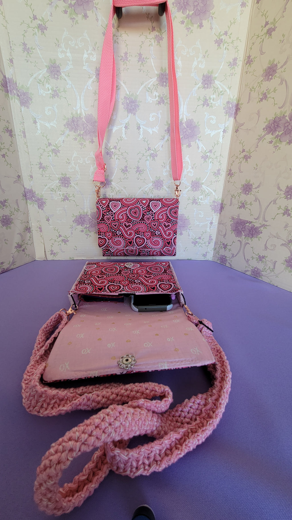 Pink Flores Clutch Purse with a ripple effect of hearts in a selection of colors pink, white, red and black.
One is open with the words xoxo and a gold heart on a light pink background pattern.