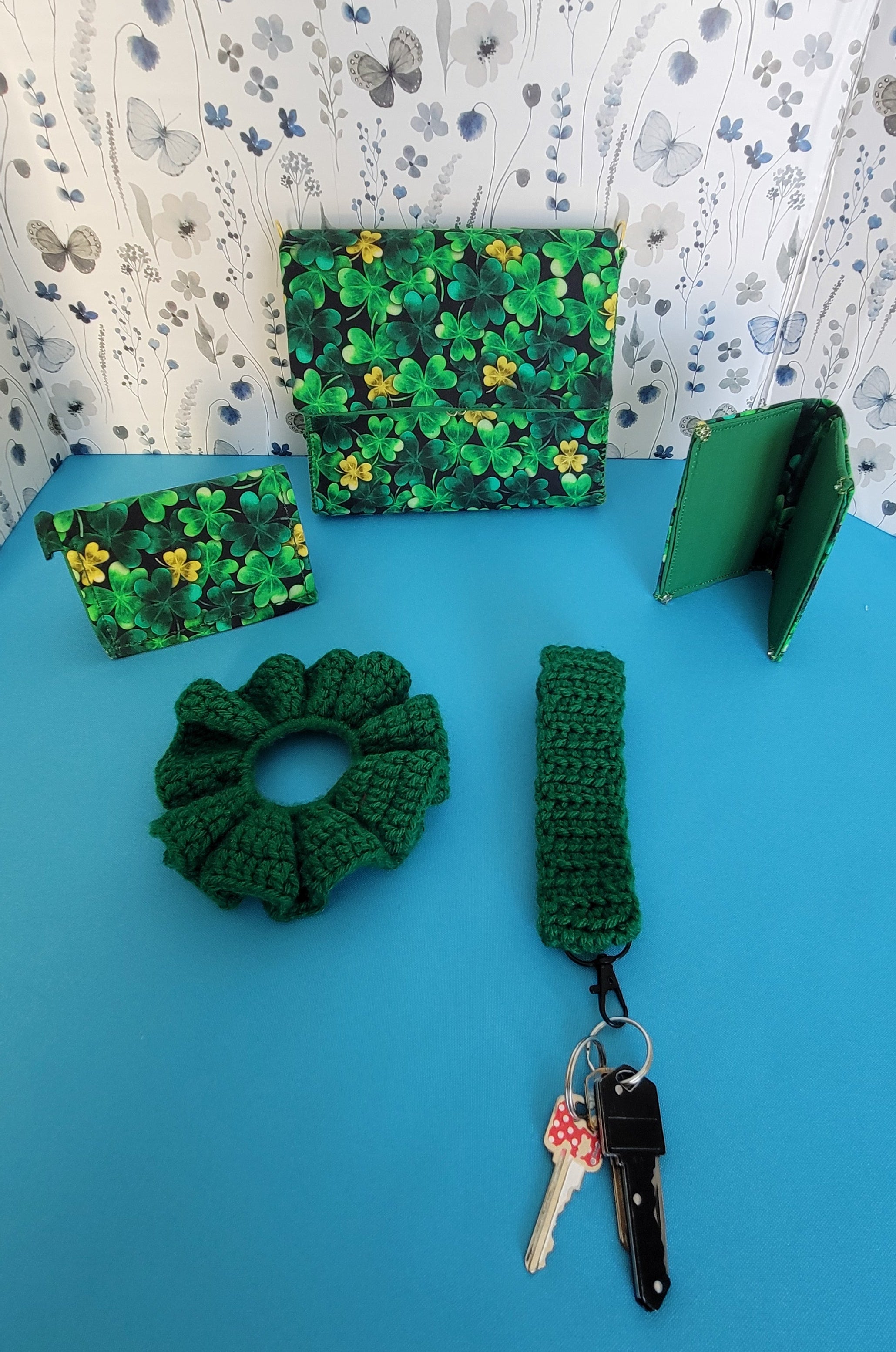 The whole Saint Patrick Clover Leaf set. A clutch purse, two wallets, a scrunchie, and. key bracelet.